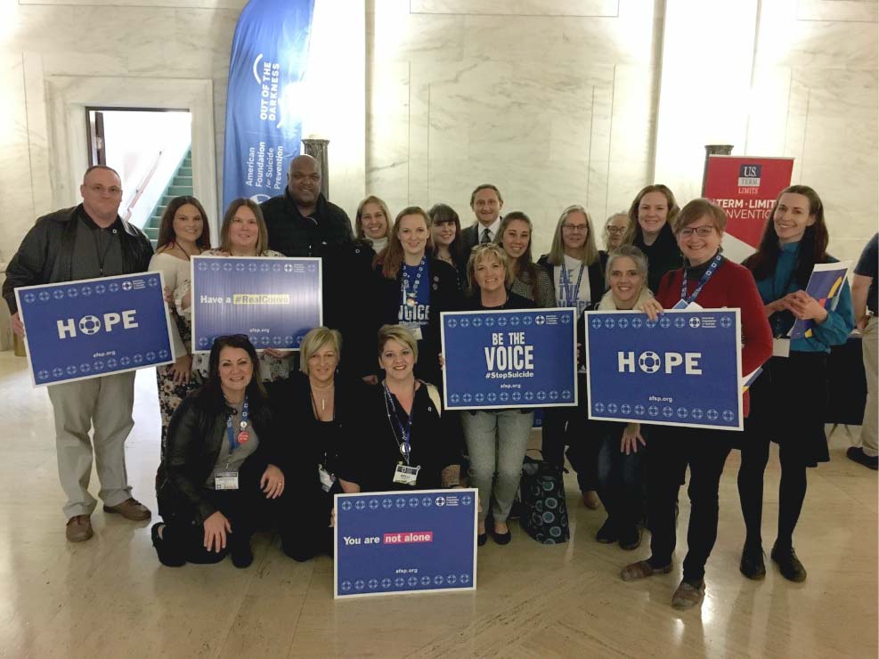 Group photo interior with AFSP placards and signs